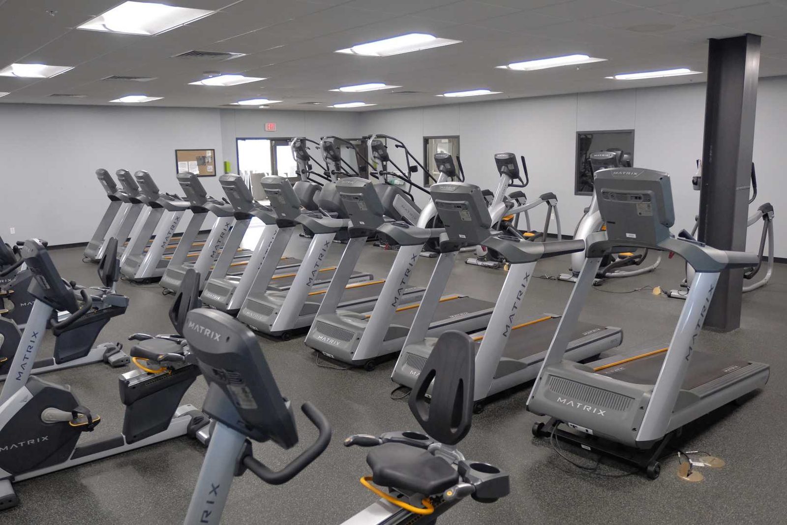 Row of Matrix treadmills, ellipticals and bikes on the cardio deck