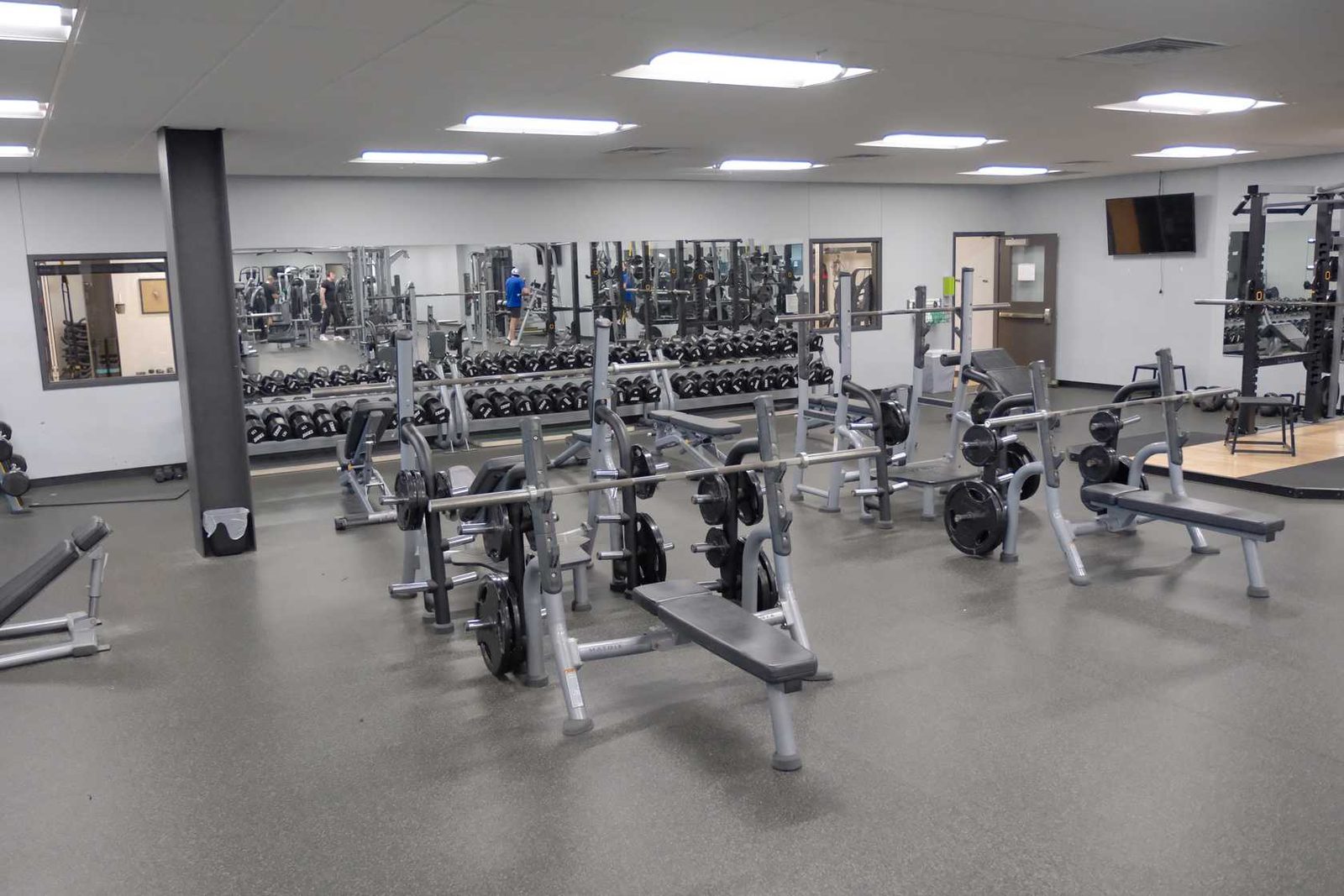 Olympic benches, squat racks and the dumbbell wall in the strength area