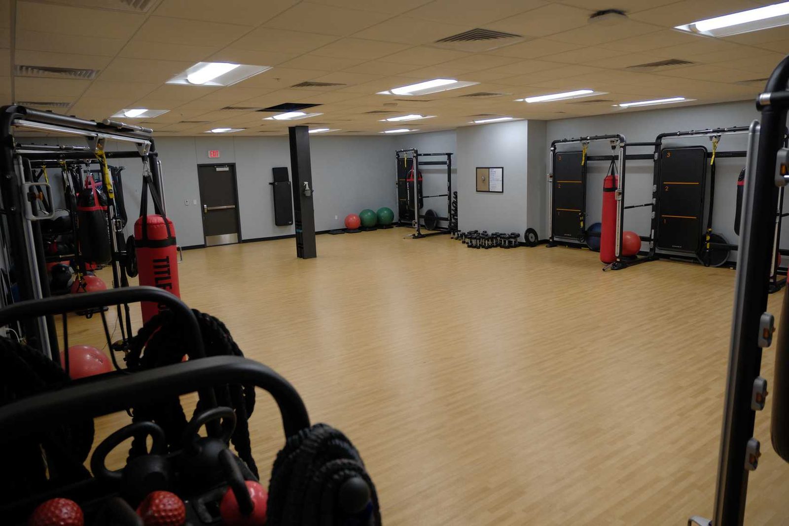 Open studio floor with heavy bags, kettlebells and battle ropes